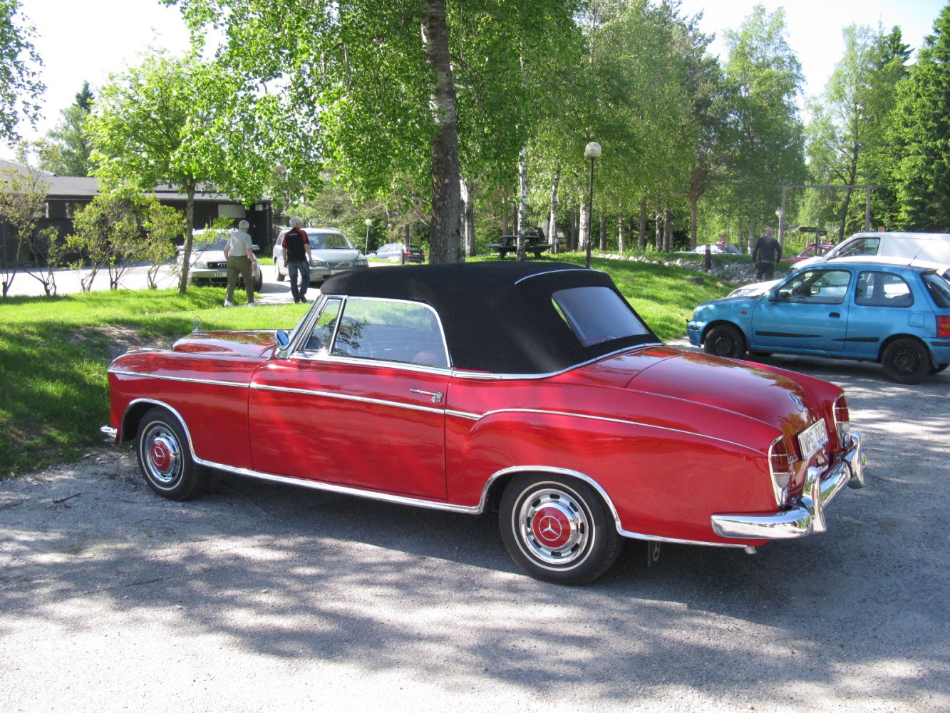 Red convertible with black soft top and chrome detailing