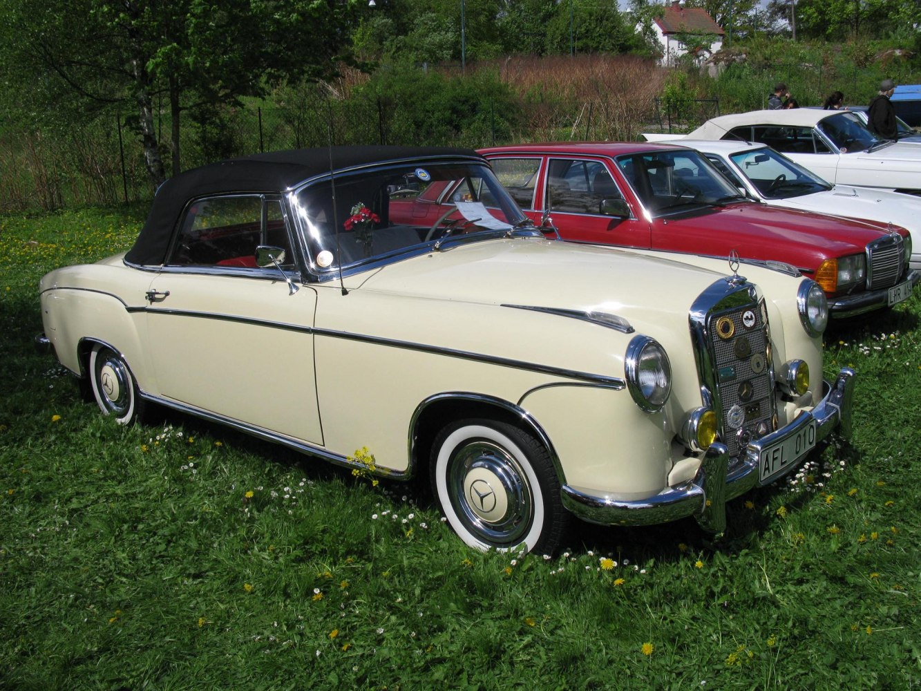 Vintage cream convertible with black soft top and chrome trim