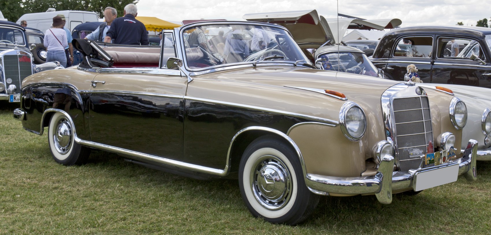 Two-tone vintage convertible with chrome grille and whitewall tires