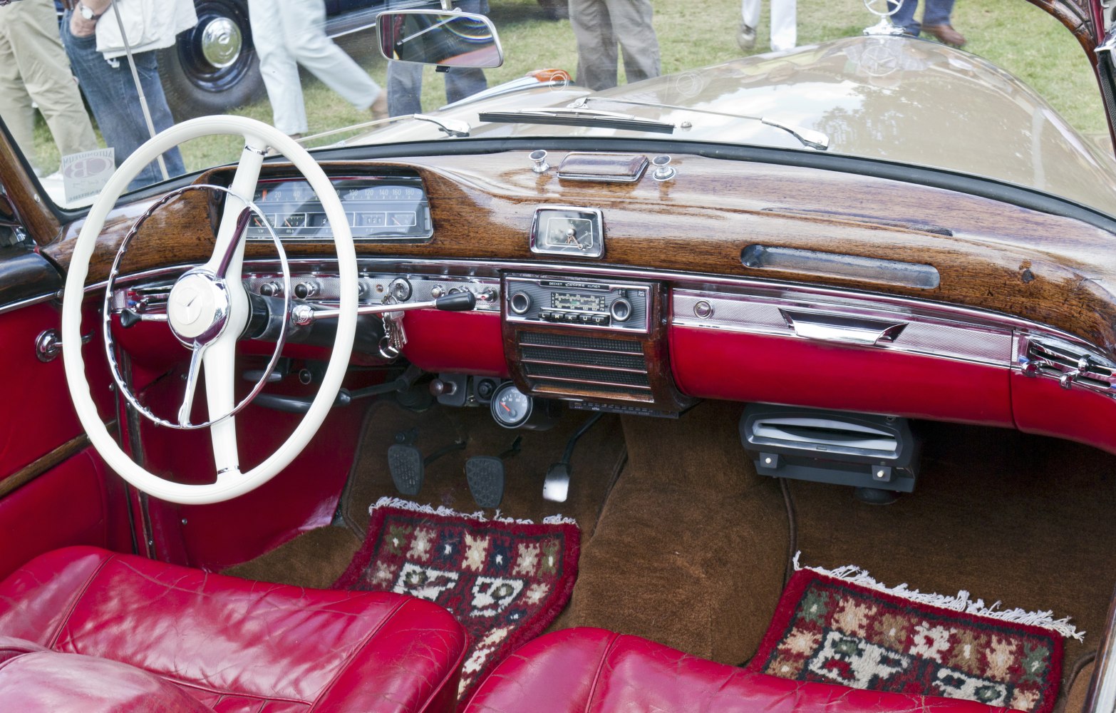 Vintage car interior with wooden dashboard and red leather seats