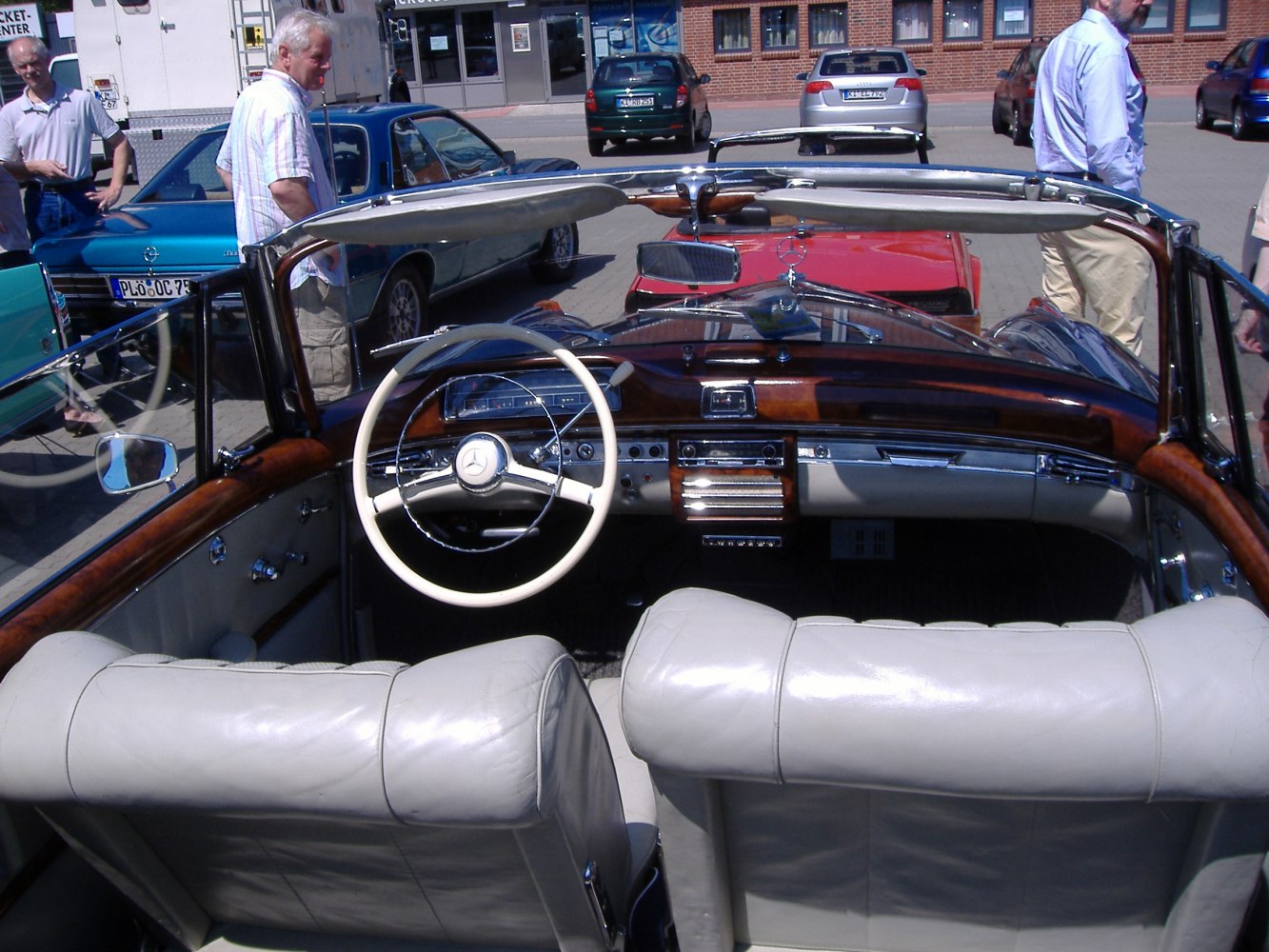 Luxurious vintage cabriolet interior with wood dashboard and white leather seats