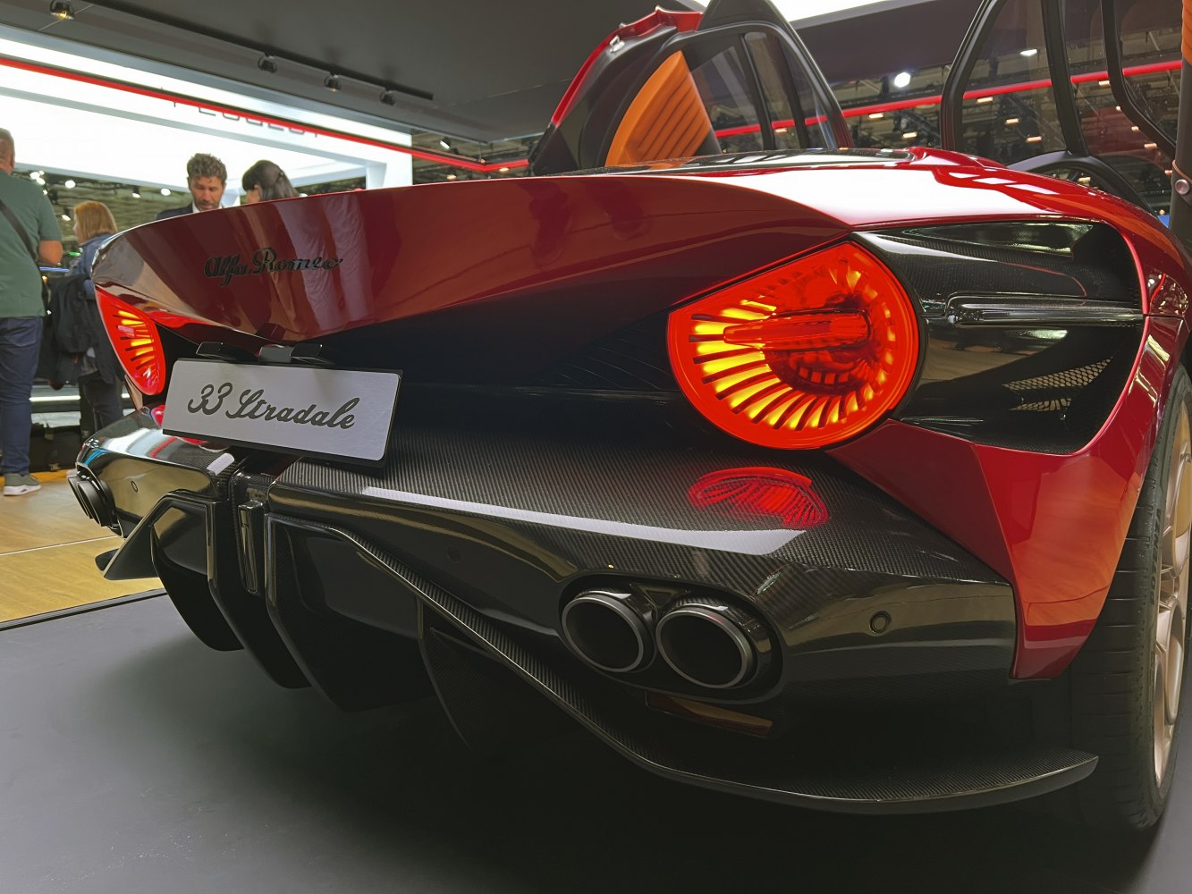 Close-up of car rear taillights and carbon fiber diffuser with quad exhaust ports