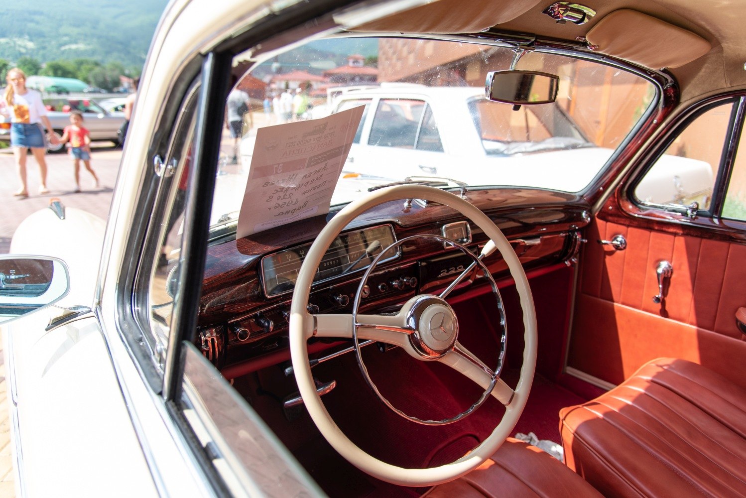 Vintage classic car interior with steering wheel and wooden dashboard