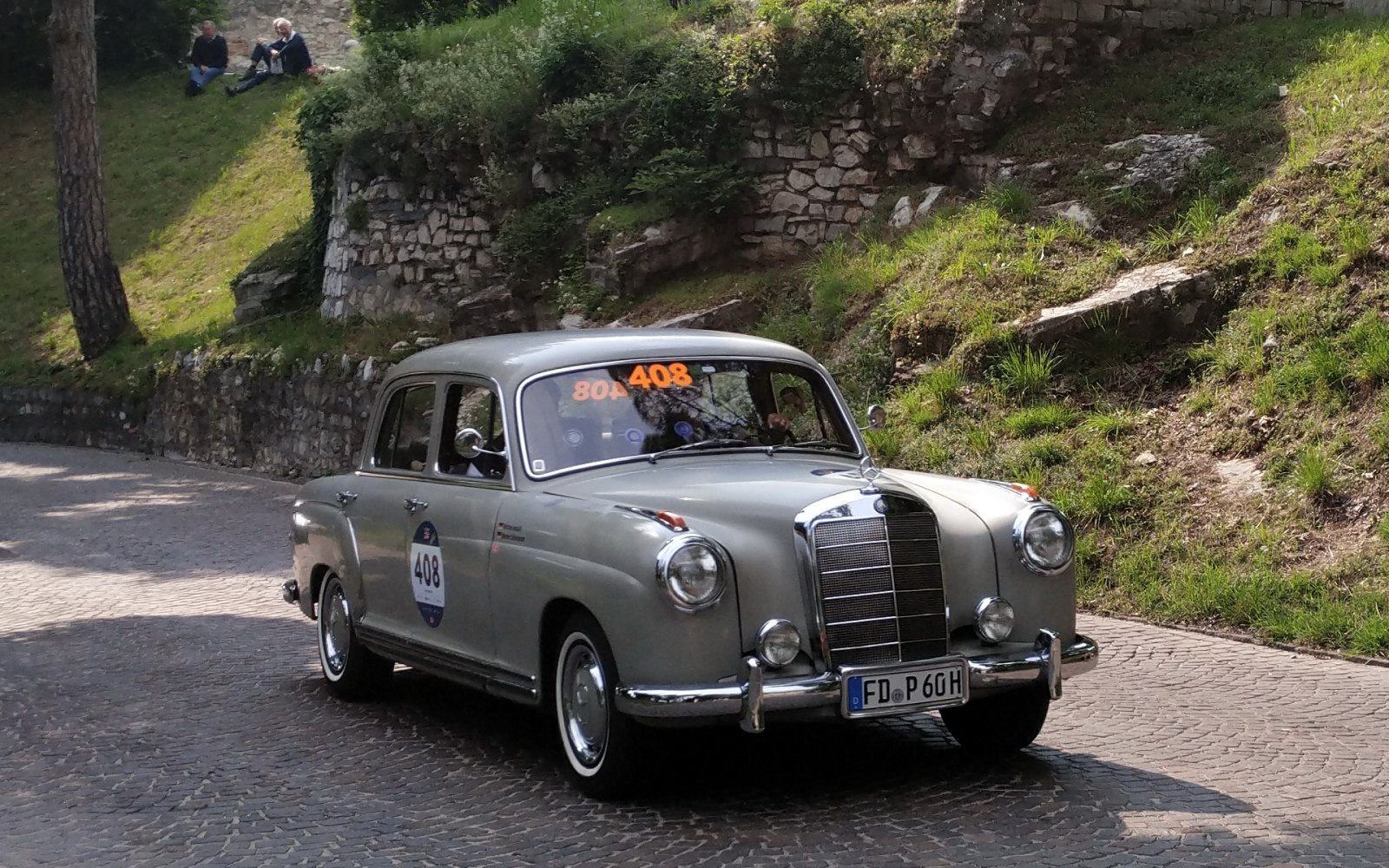 Four-door vintage sedan with large chrome grille and round headlights