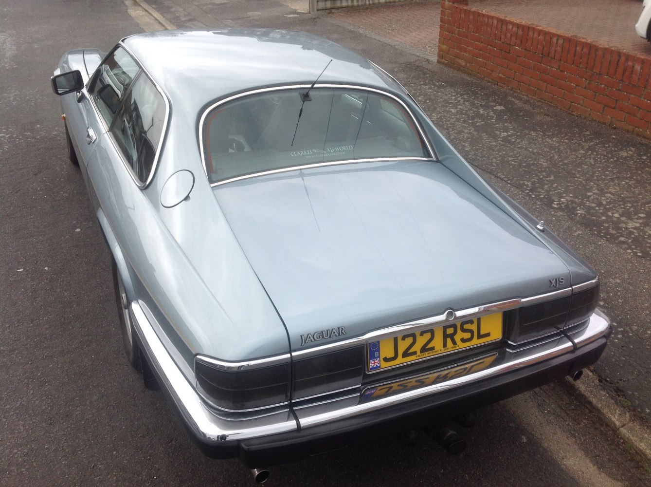 Classic coupe rear with chrome trim and distinctive tail lights