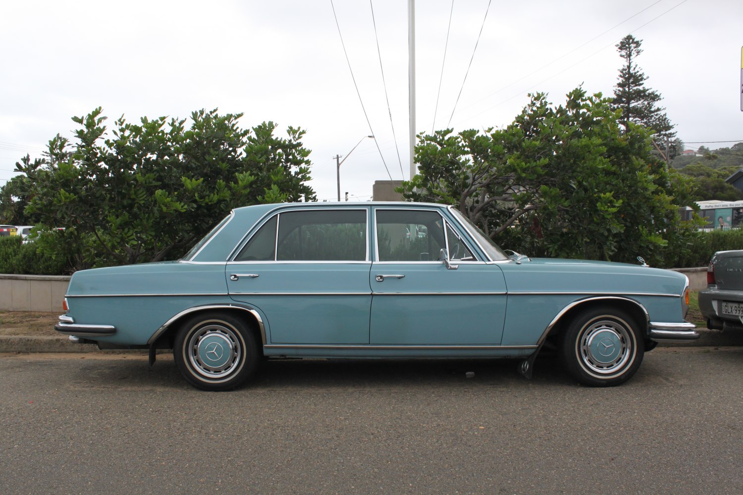 Vintage sedan with chrome trims and classic hubcaps