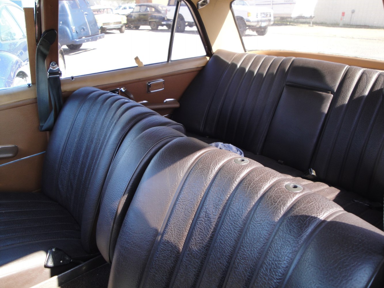 Classic vintage leather seating with textured upholstery and spacious rear bench.