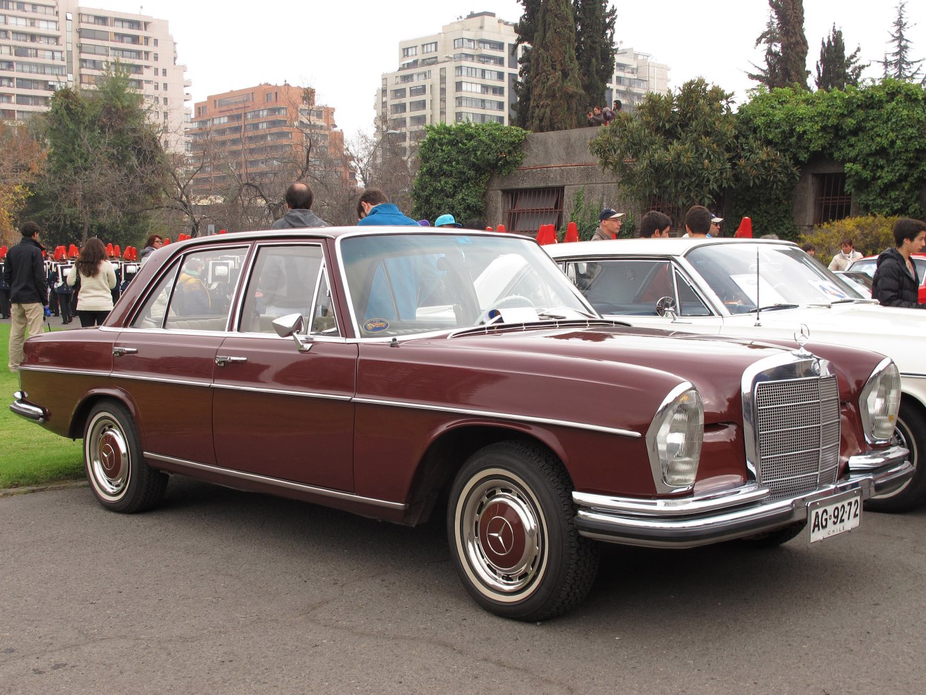 Vintage sedan with classic front grille, chrome bumper, and hubcap wheels