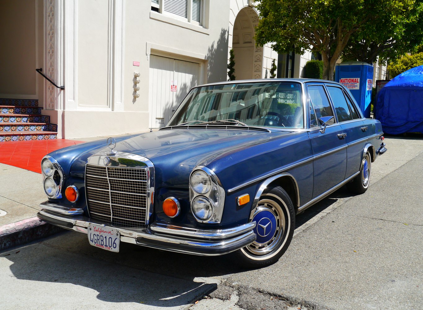 Vintage sedan with large chrome grille and stacked round headlights