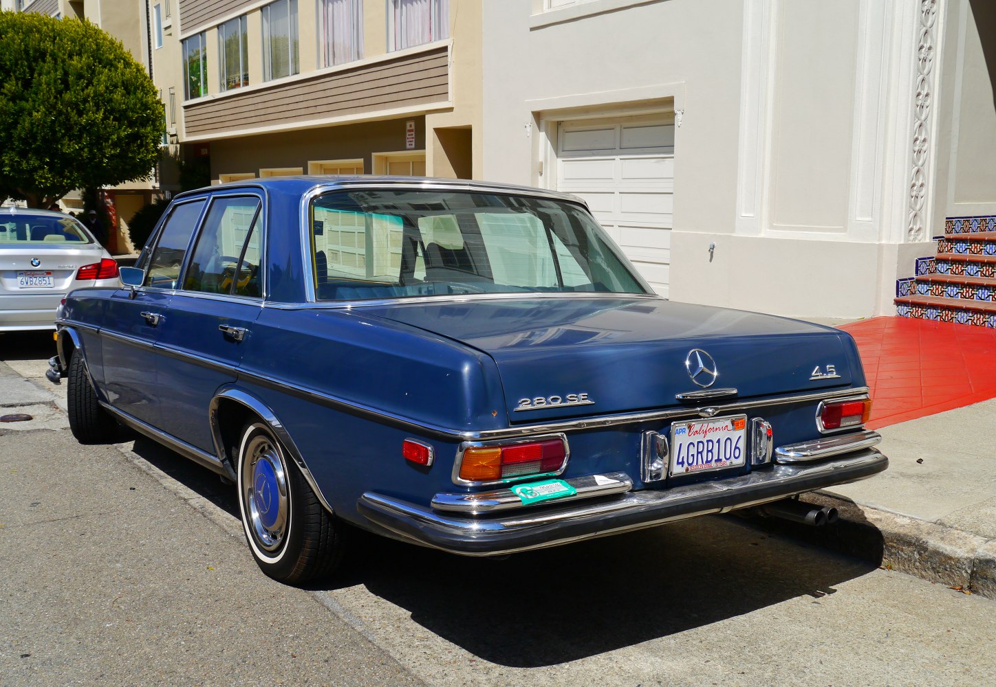 Classic blue vintage sedan rear view with chrome bumpers and distinctive tail lights