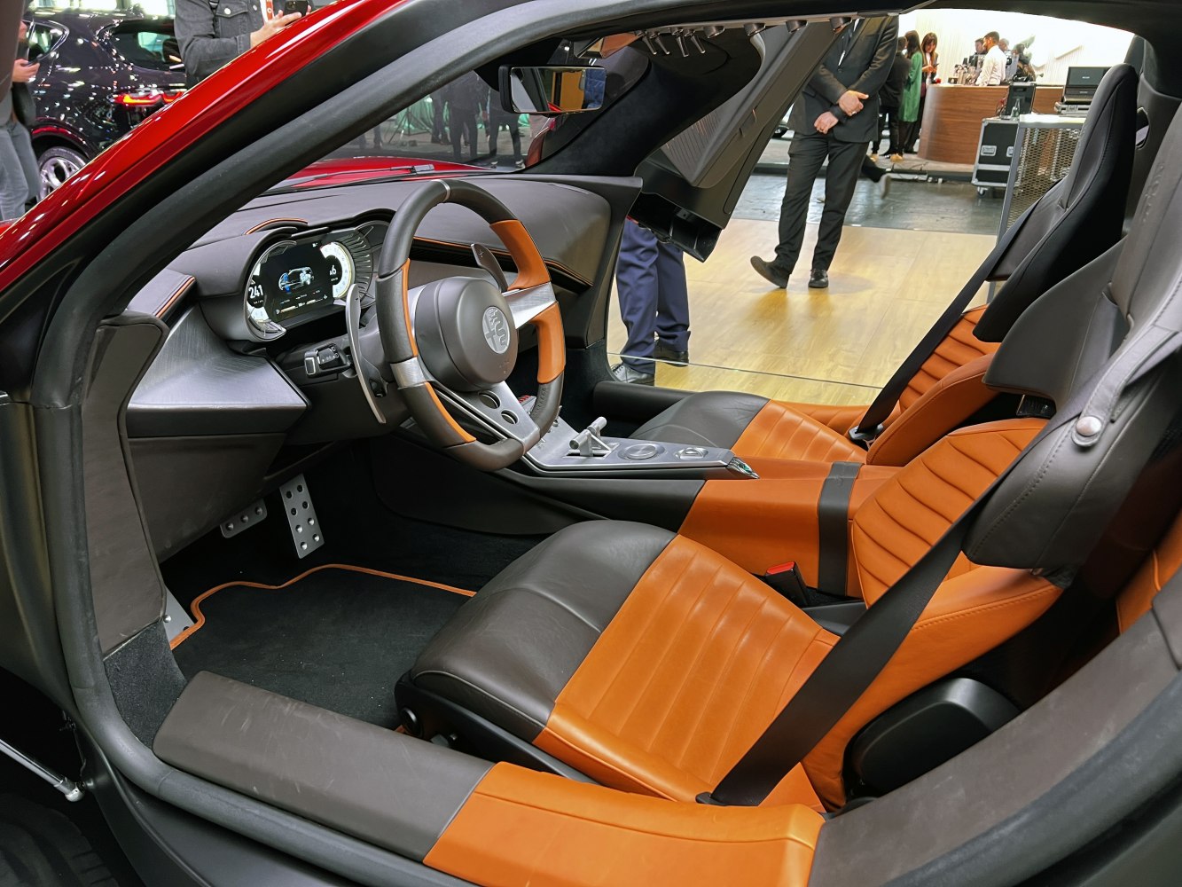 Modern luxury car interior with digital dashboard and two-tone leather sport seats