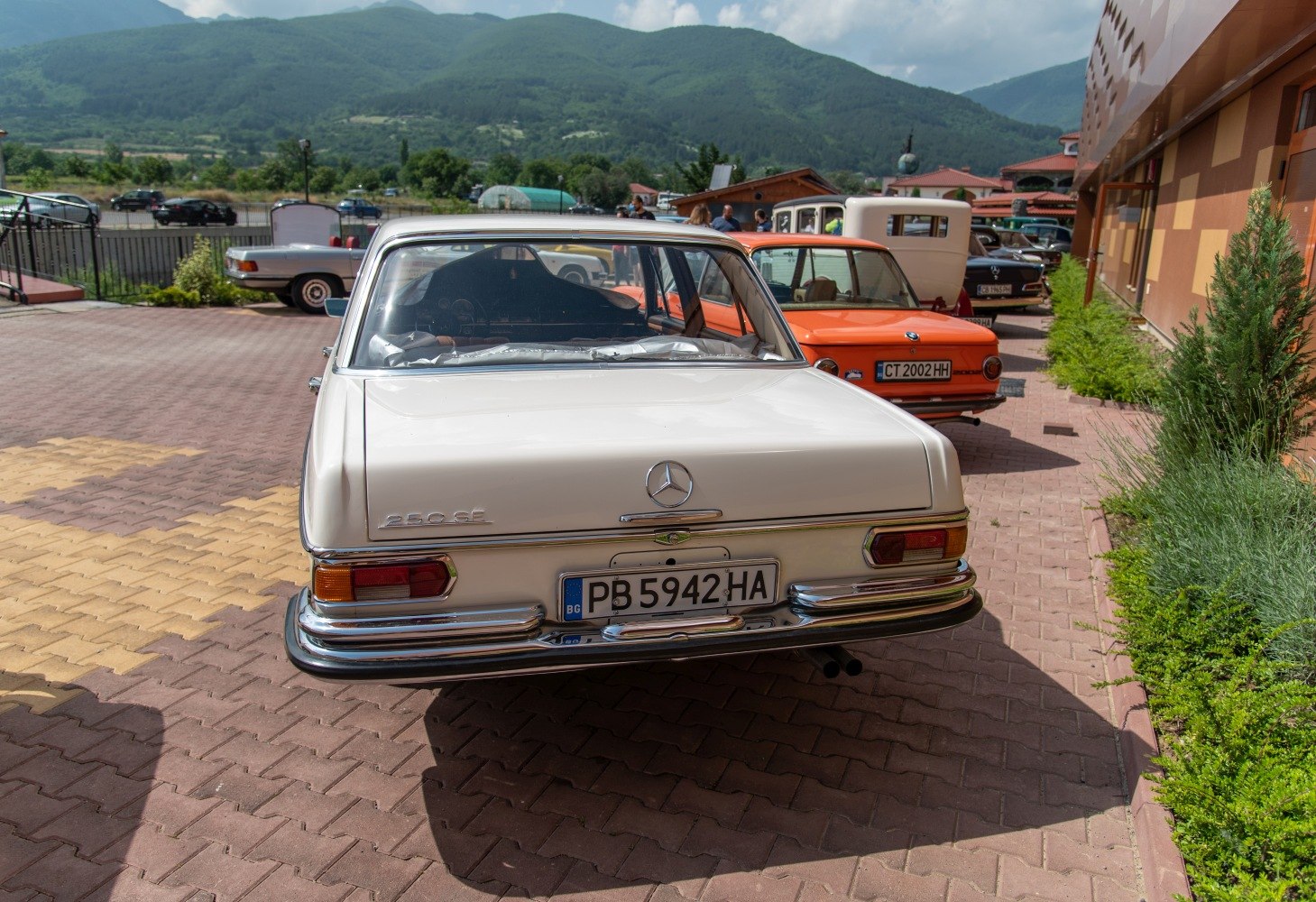 Rear view of vintage 1960s sedan with rectangular taillights and chrome bumper