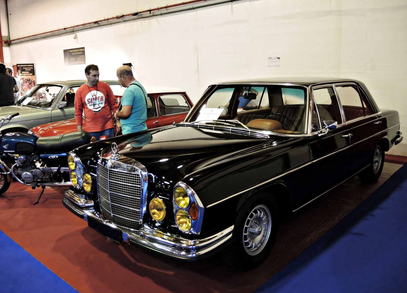 Luxury vintage sedan with yellow headlights and prominent chrome grille
