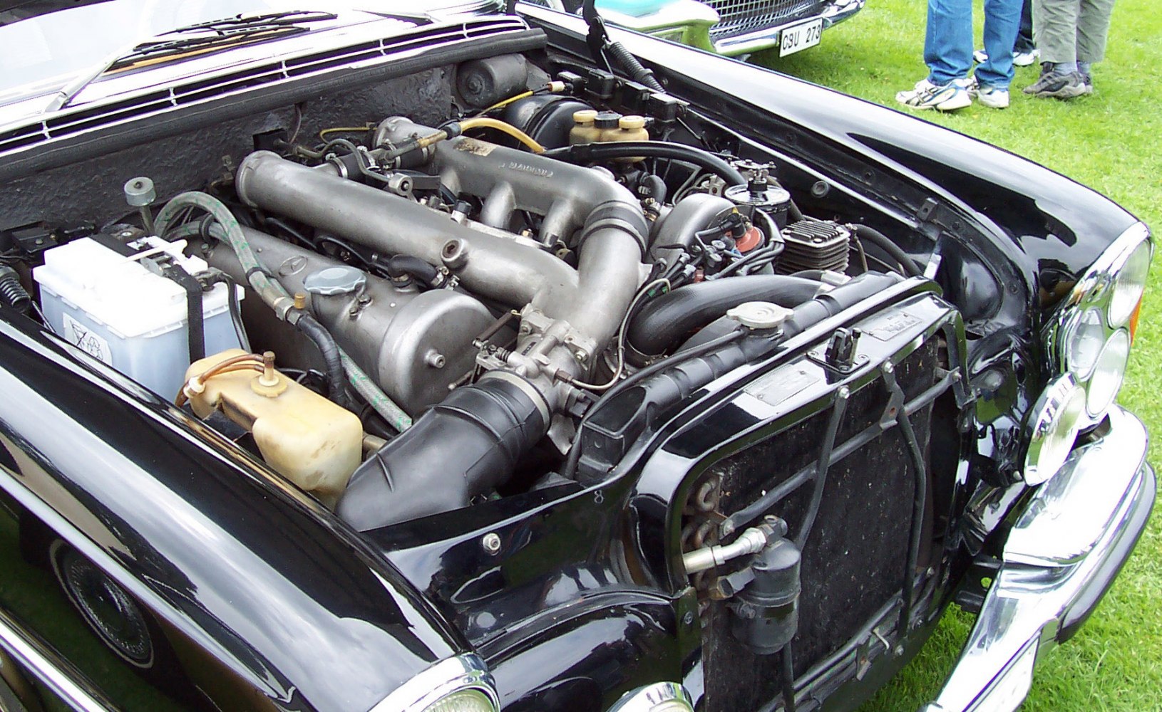 Vintage internal combustion engine bay with battery and radiator