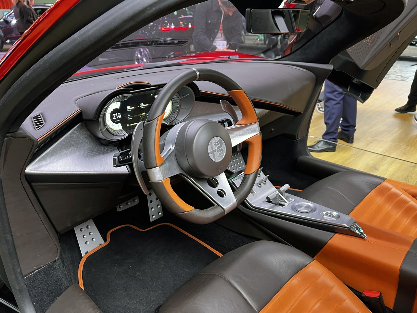 Luxury sporty car interior with digital dashboard and unique steering wheel.