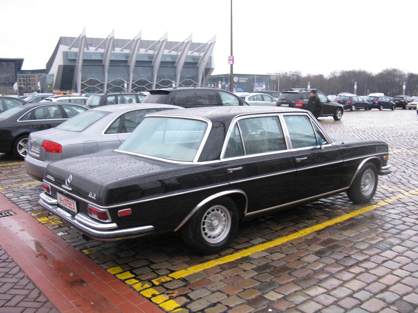 Classic luxury sedan with chrome trim and vintage steel wheels.