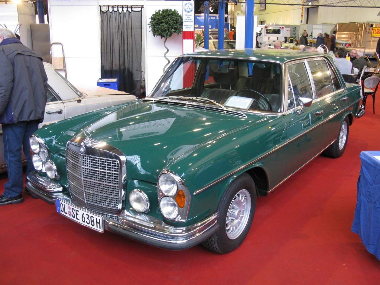 Classic green sedan with quad circular headlights and chrome grille