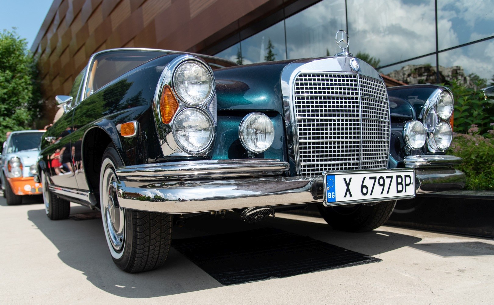 Vintage cabriolet with prominent chrome grille and stacked round headlights