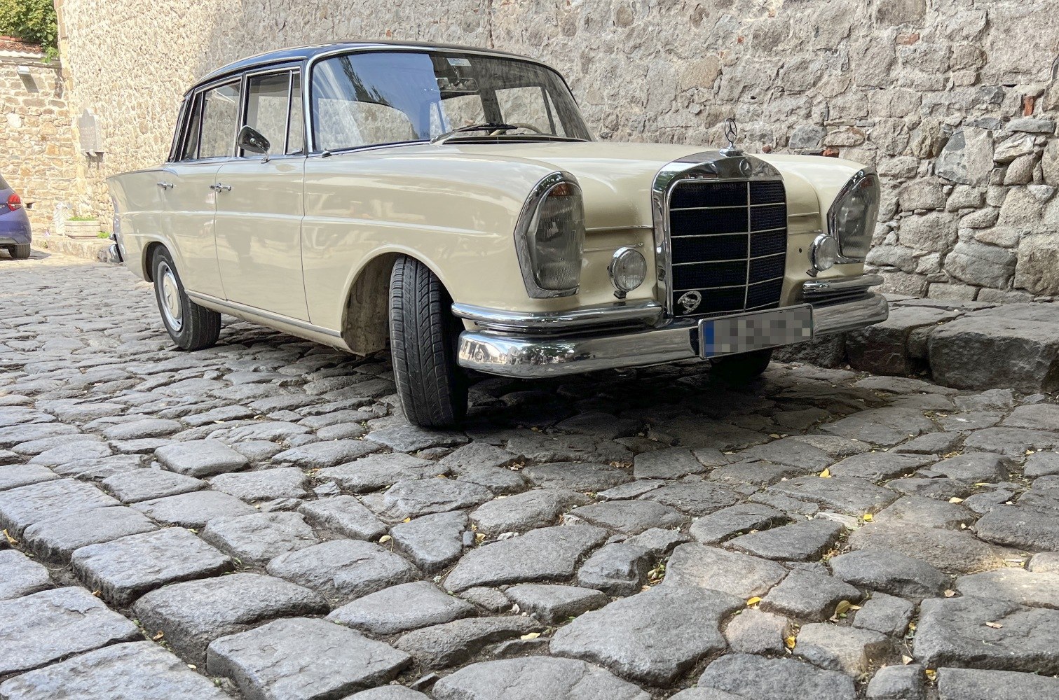 Classic front and side view of a vintage coupe with distinct grille.
