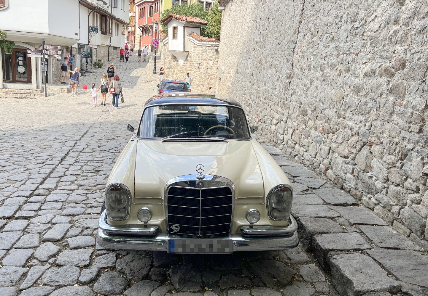 Front view on vintage coupe with chrome grille and round headlights