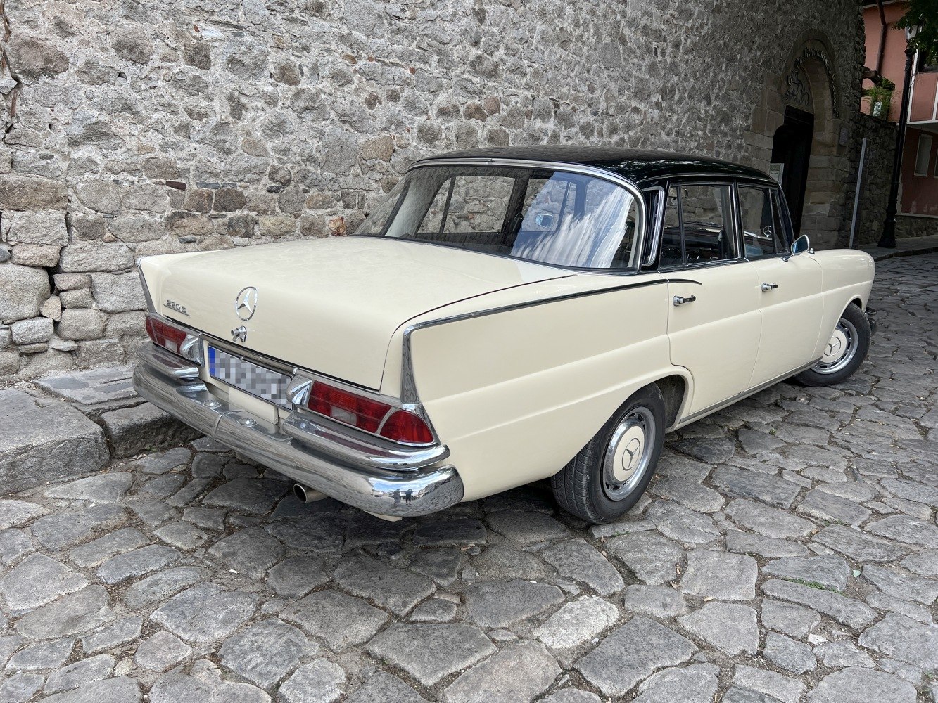 Classic vintage car rear with two-tone paint and chrome bumper