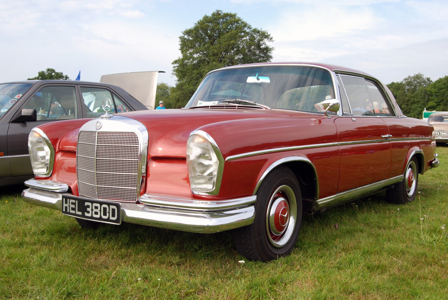 Wide chrome grille and distinctive round headlights on a classic vintage coupe.