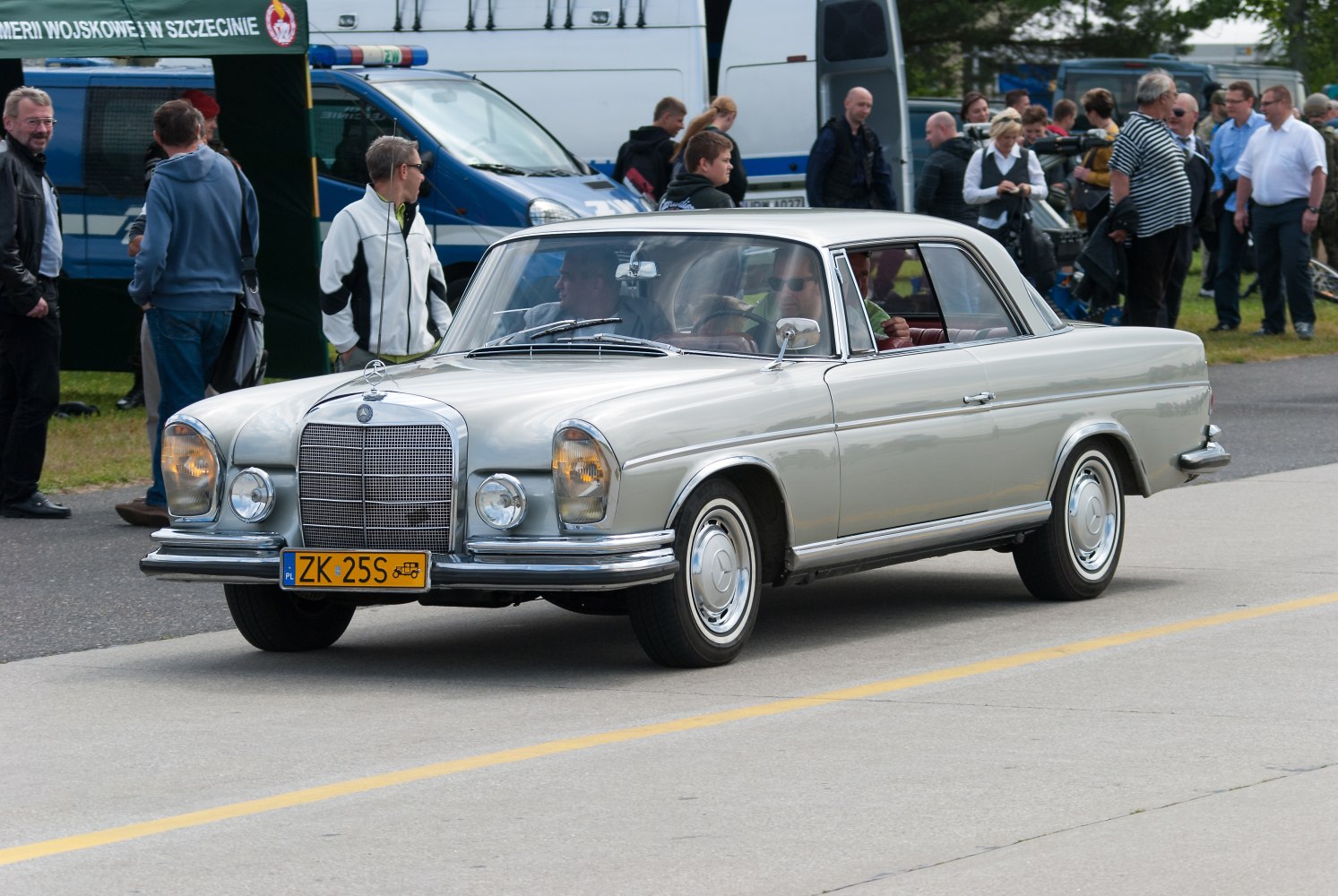 1960s luxury two-door coupe with chrome grille and vintage styling