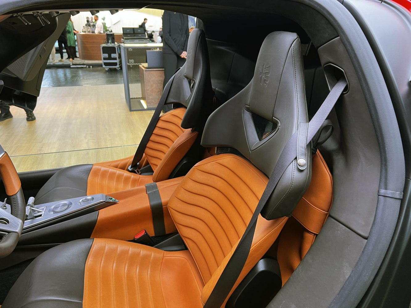 Premium leather sports seats with integrated headrests and seatbelts