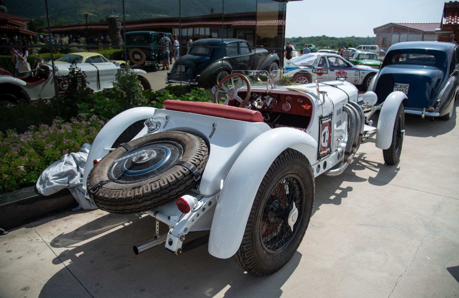 Vintage open-top roadster rear with spare tire and prominent white fenders