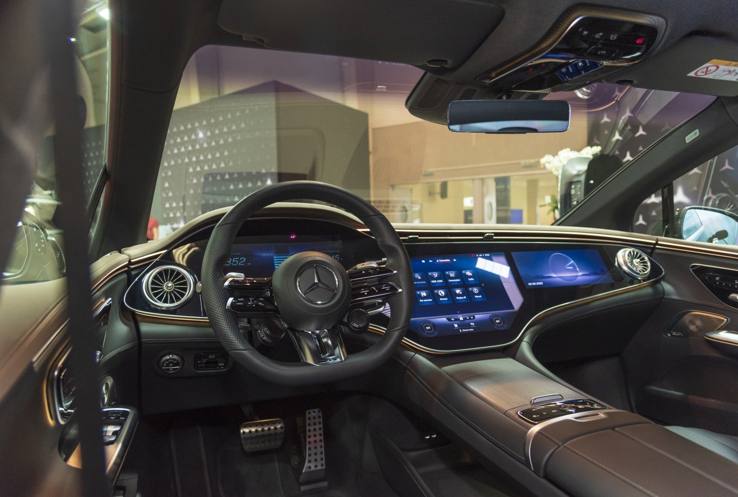 Digital instrument cluster and touchscreen infotainment in luxury electric car interior