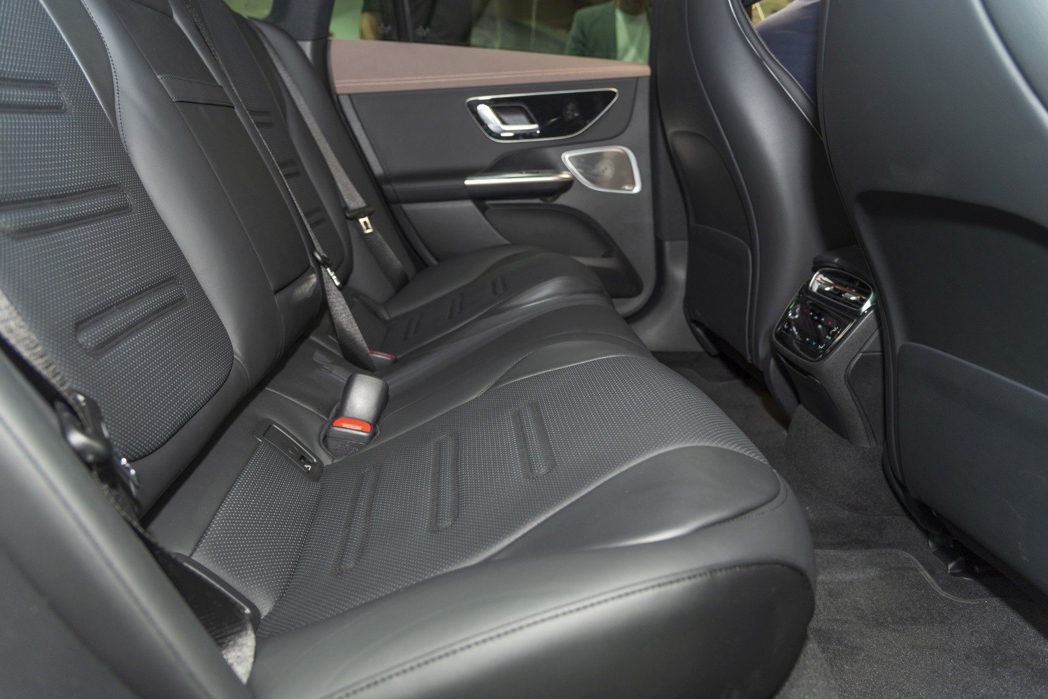 Luxurious rear seat interior with leather upholstery and comfort features