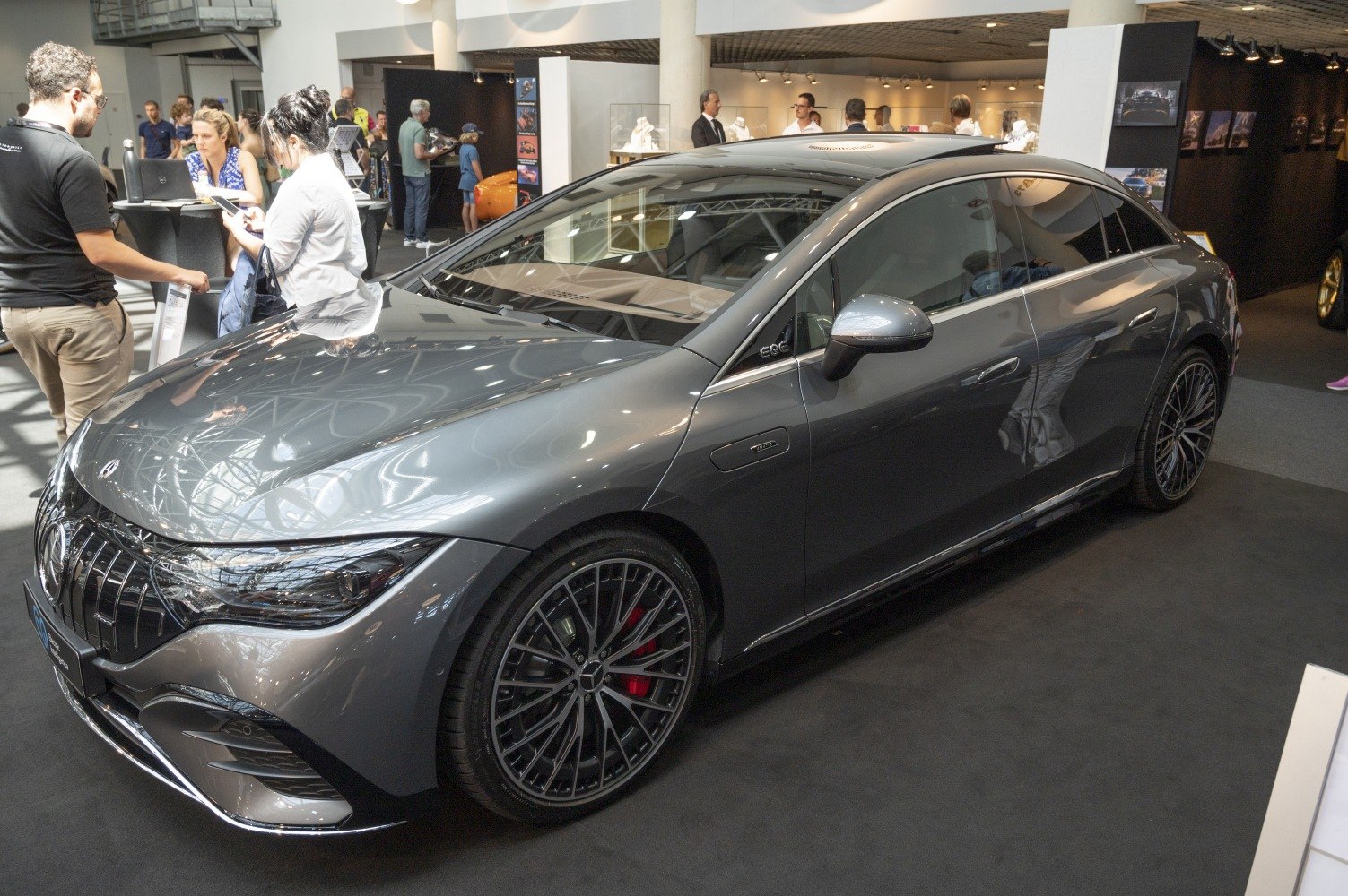 Electric luxury sedan with aerodynamic profile and multi-spoke wheels