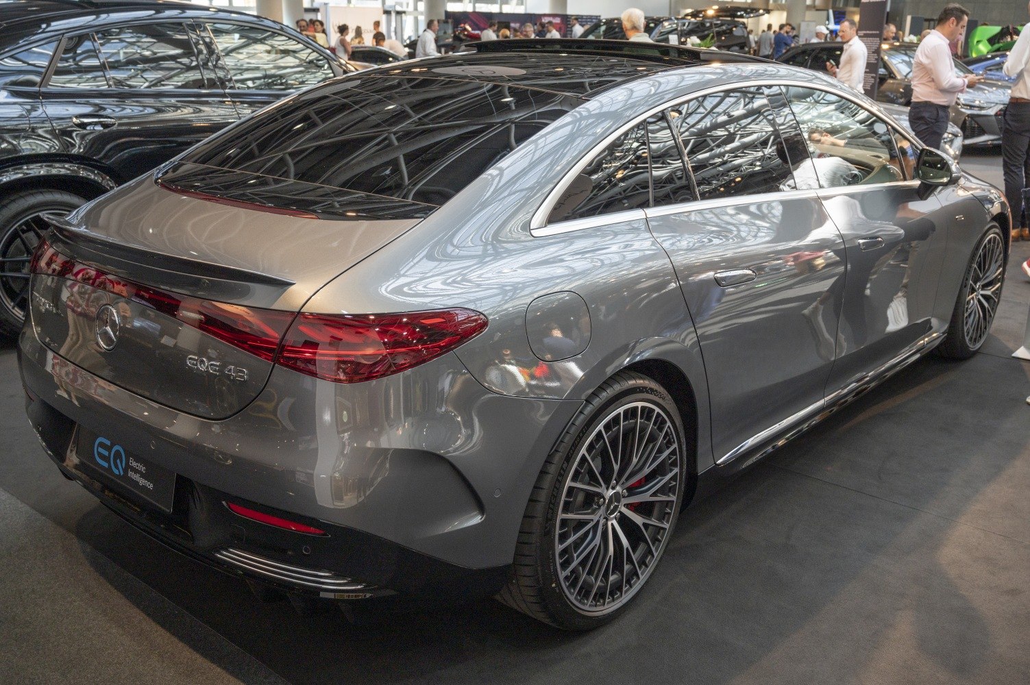 Rear side view of a sleek electric sedan with aerodynamic shape and large alloy wheels