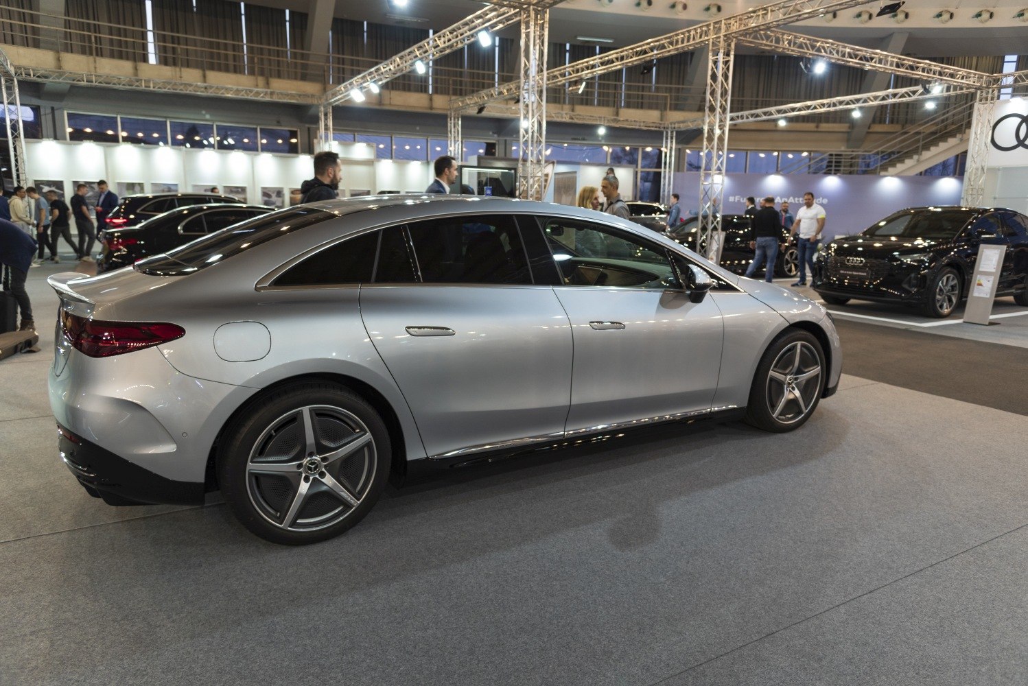 Silver electric luxury sedan side view with aerodynamic design