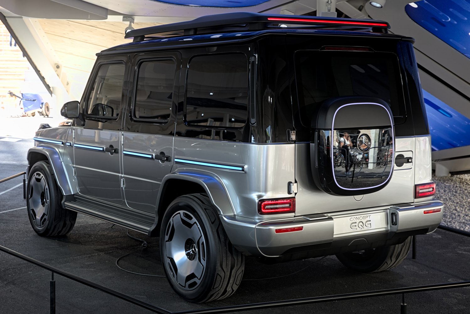 Rear view of futuristic electric SUV with unique taillights and spare tire cover