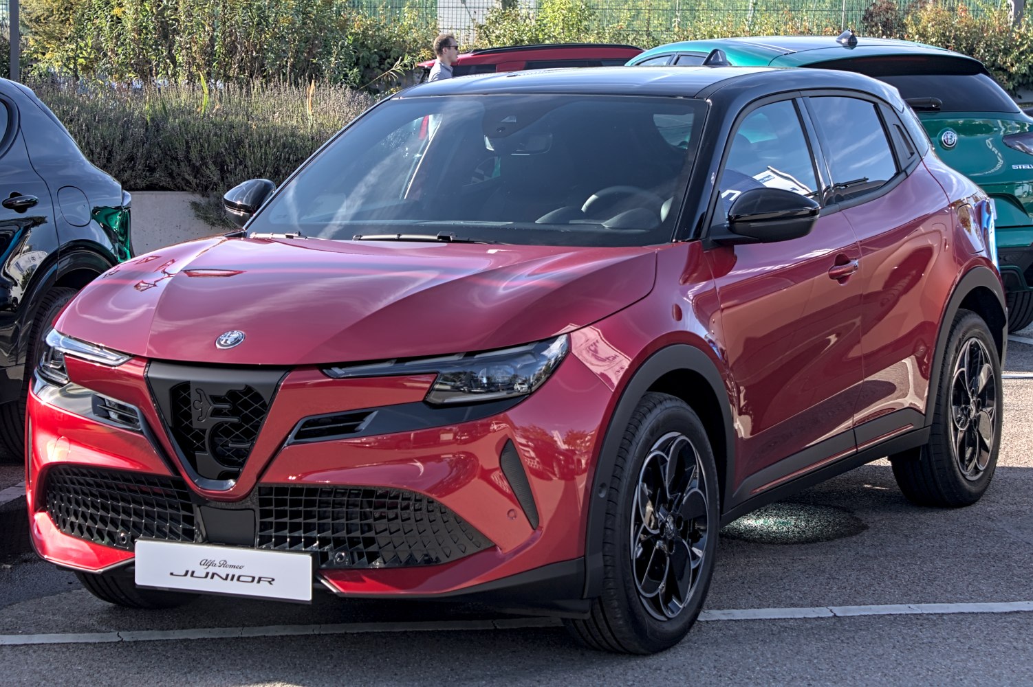 Front view of a red compact SUV with black roof and alloy wheels.