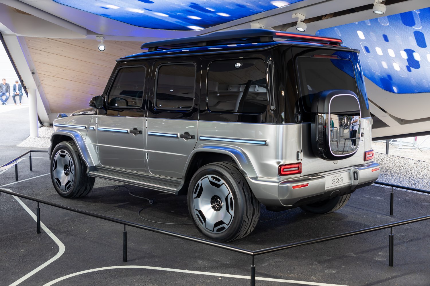 Rear-side view of SUV with futuristic wheels and rear spare tire cover