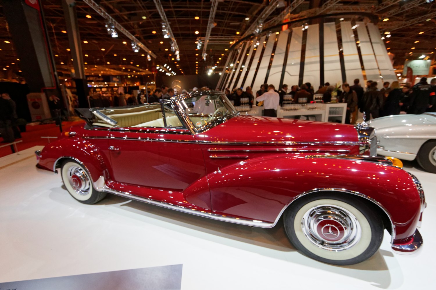 Red convertible roadster with whitewall tires and beige interior