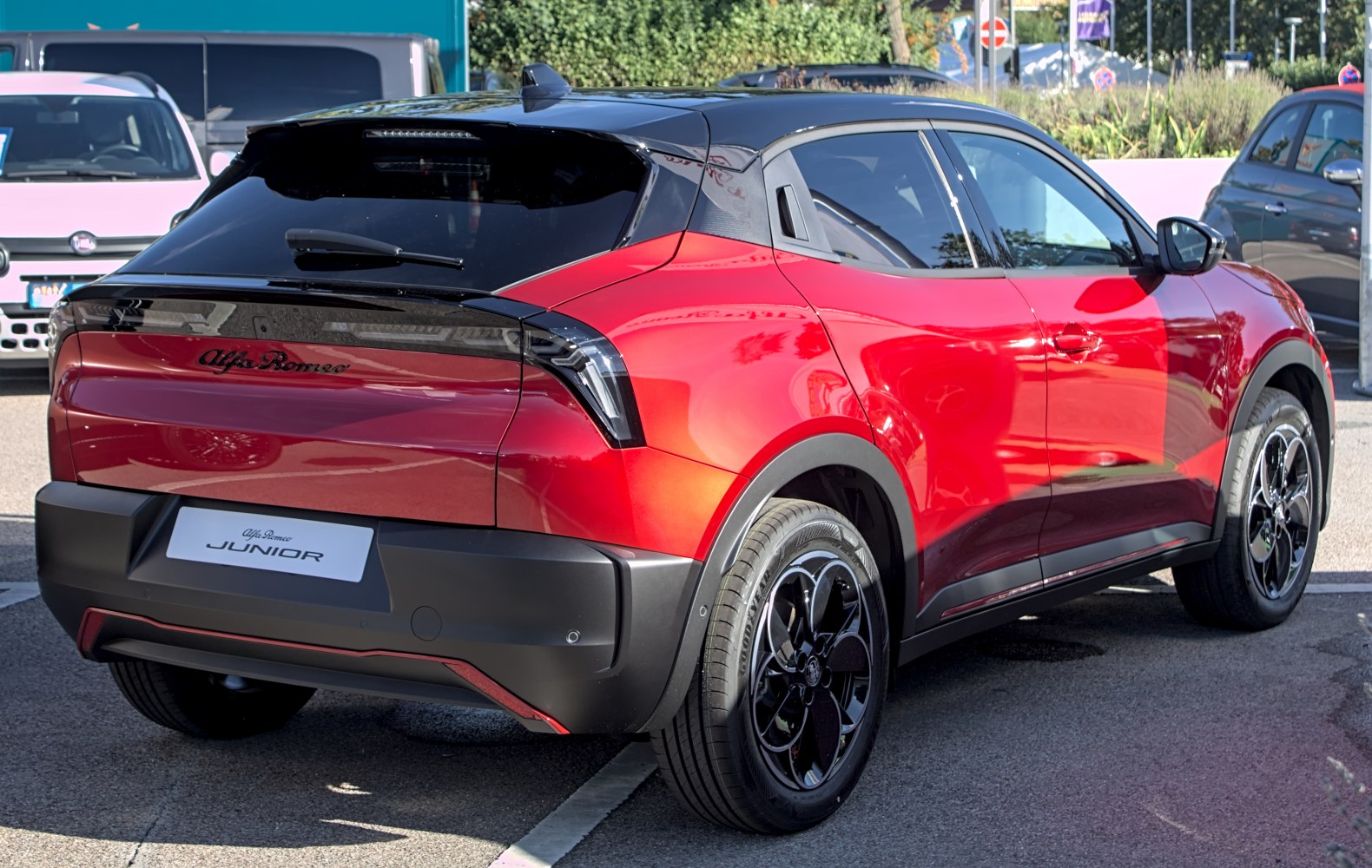 Red compact SUV rear with black roof, modern tail lights, and sporty design.