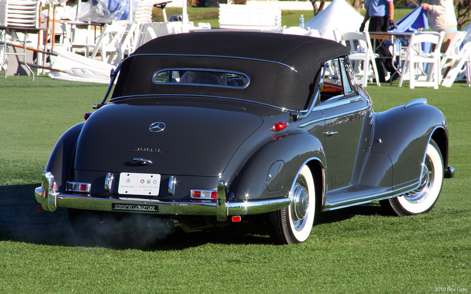 Rear view of a vintage convertible with soft top and whitewall tires