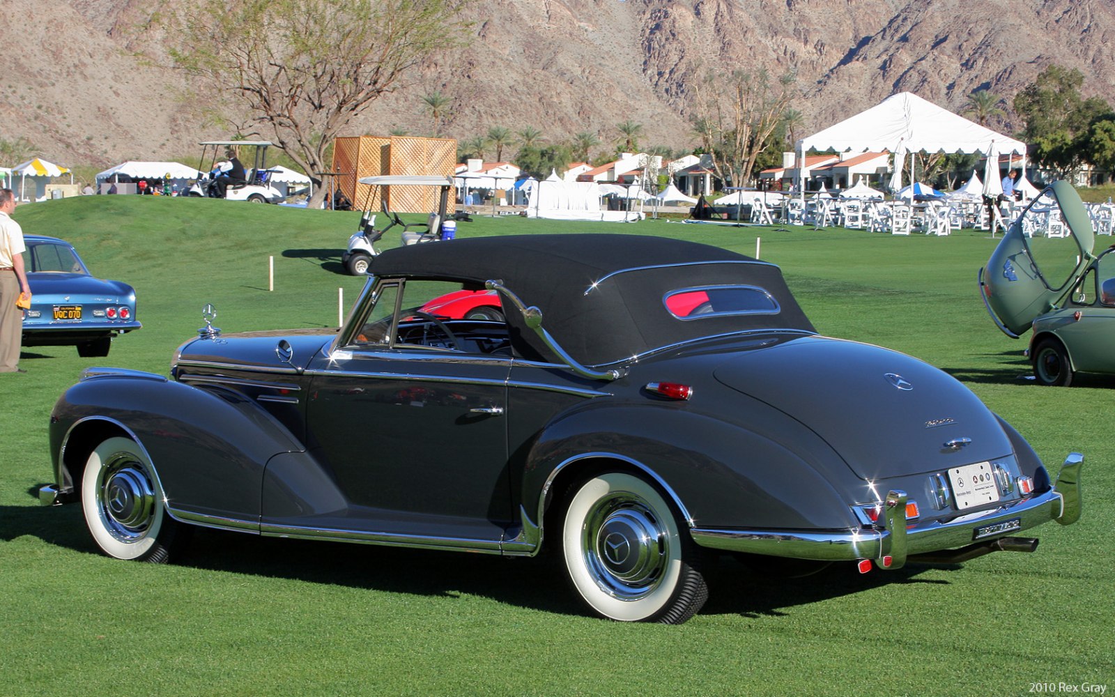 Vintage convertible with black soft top and wide whitewall tires
