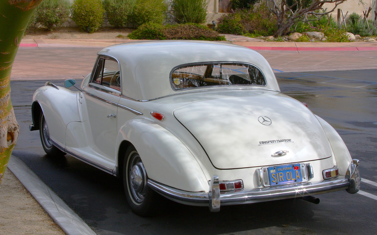 Rear view of vintage luxury coupe with smooth curves and chrome accents