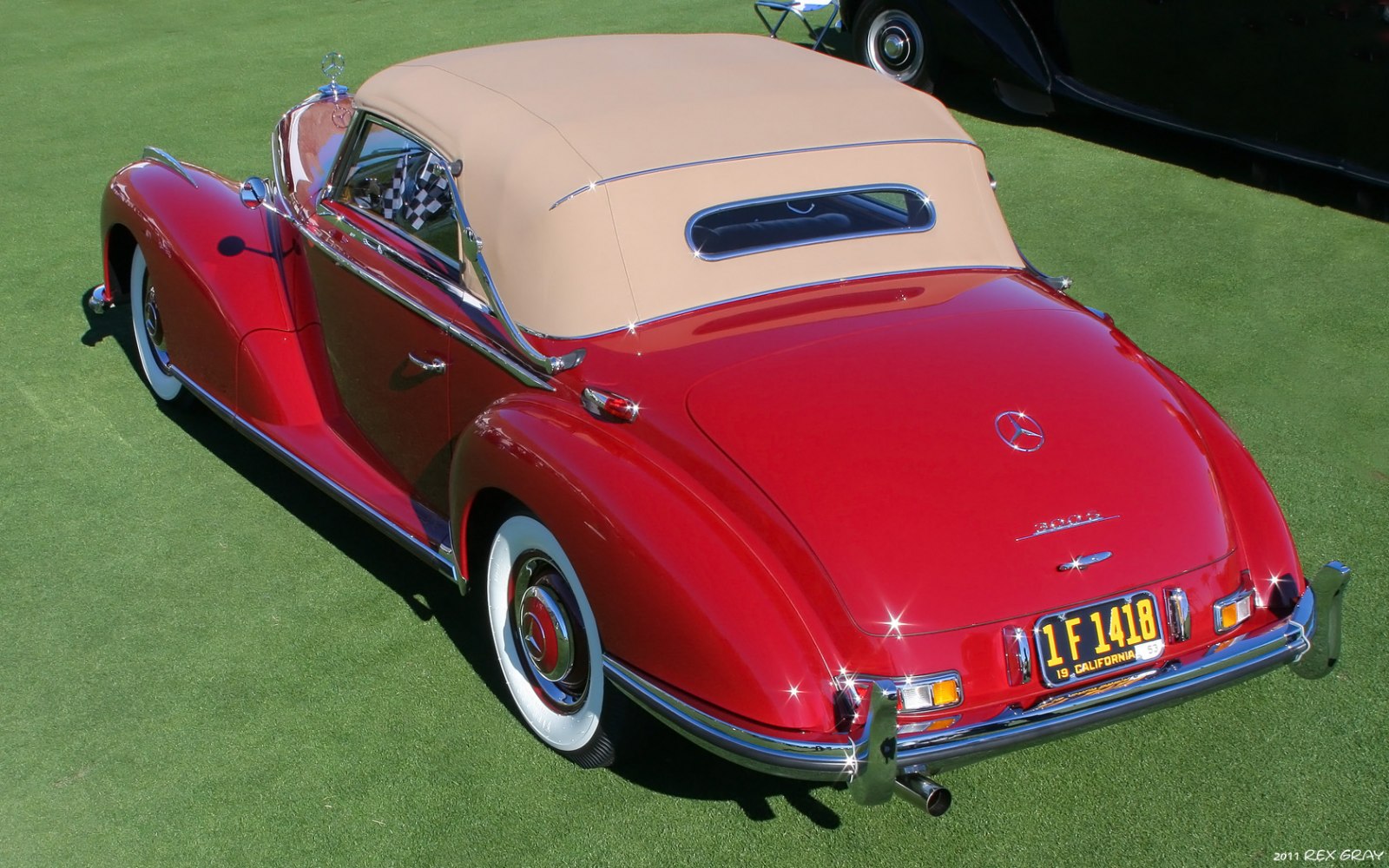 Red convertible with tan soft top and chrome details.