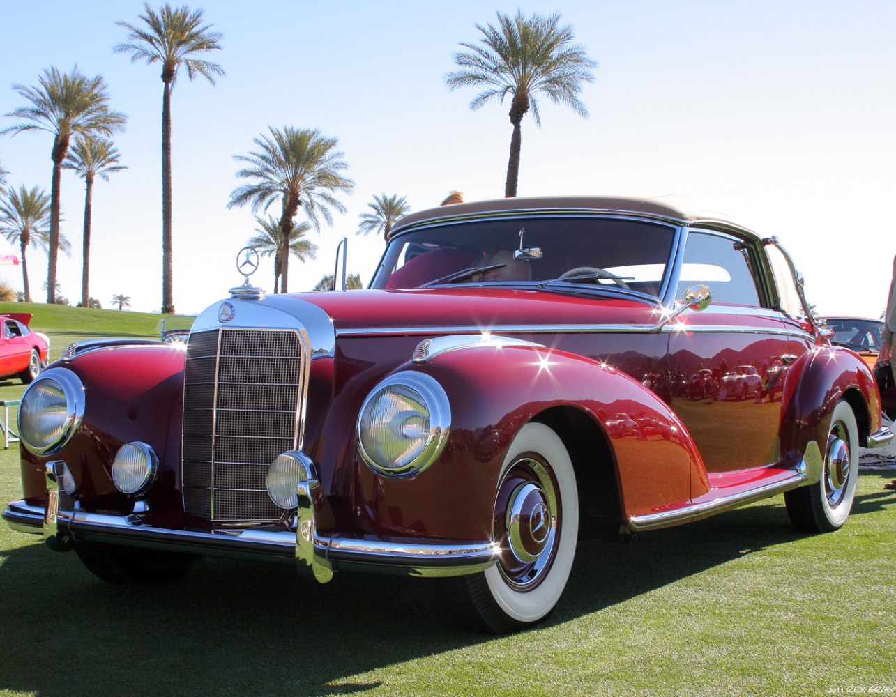 Classic vintage convertible front view with chrome grille and whitewall tires