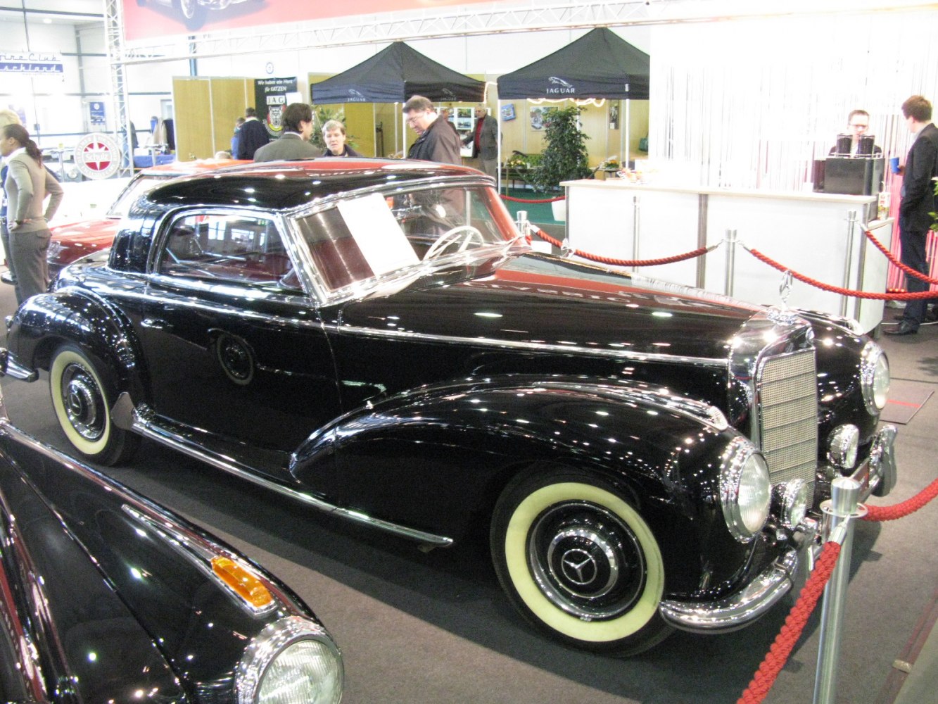 Black vintage luxury coupe with whitewall tires and chrome details