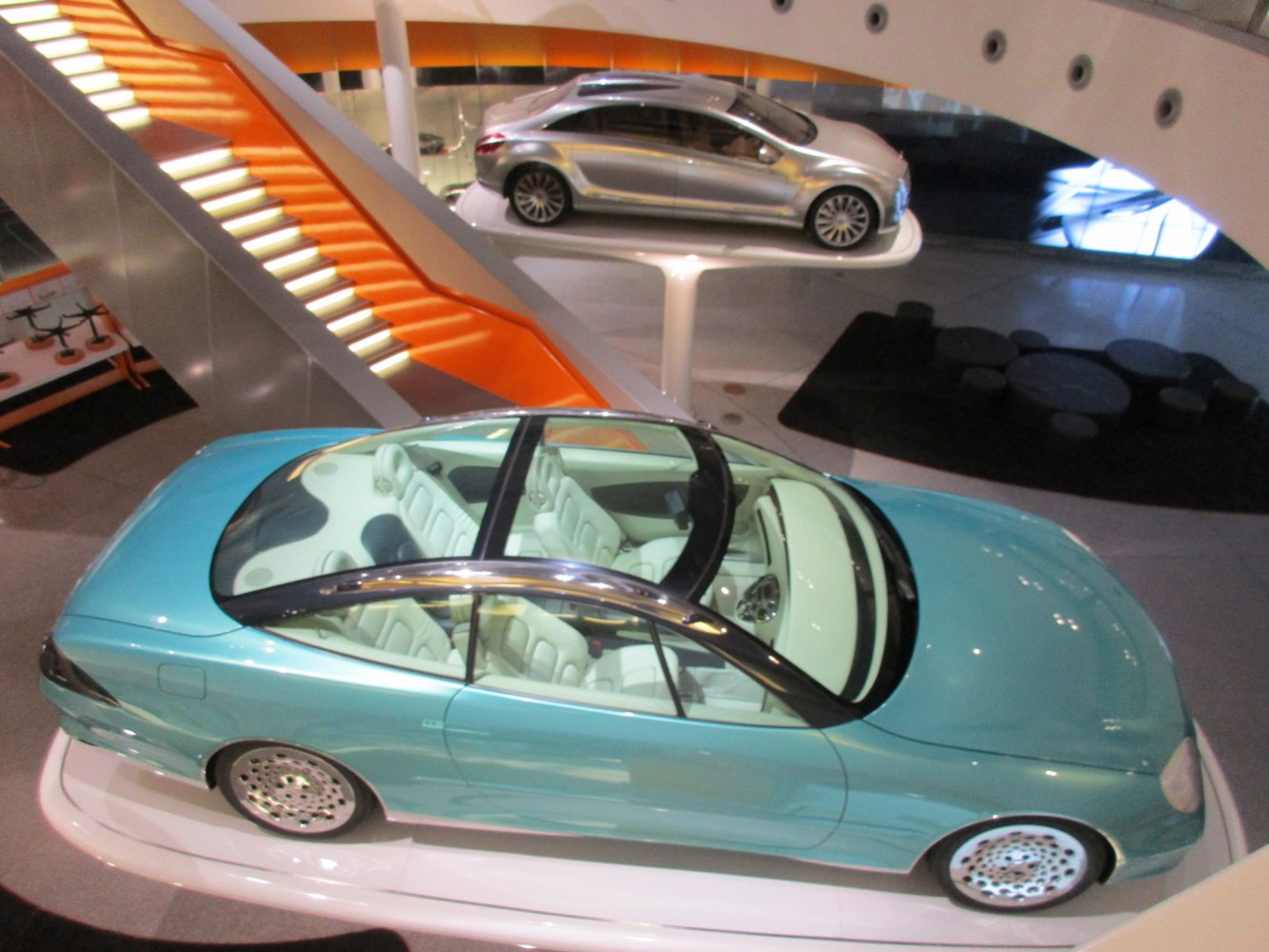 Futuristic concept car with panoramic glass roof and spacious interior seating.