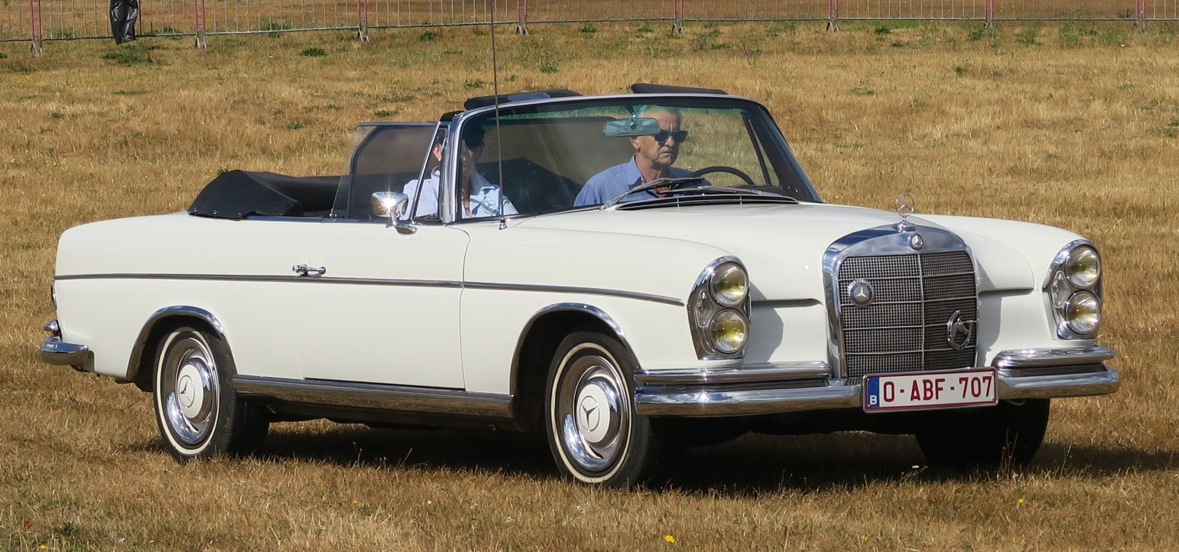 Convertible with dual round headlights, chrome grille, and polished rims