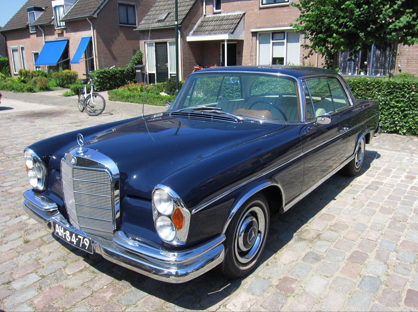 Vintage coupe with chrome grille and dual stacked headlights