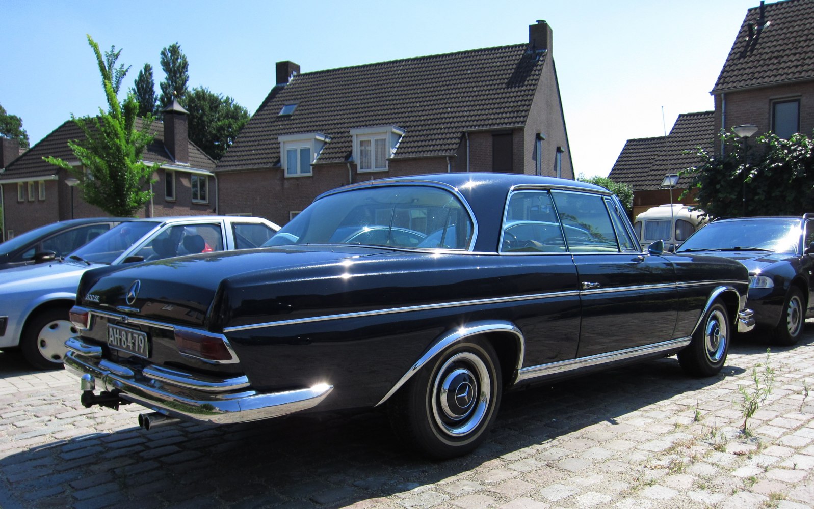 Vintage two-door coupe with rounded rear and chrome trim