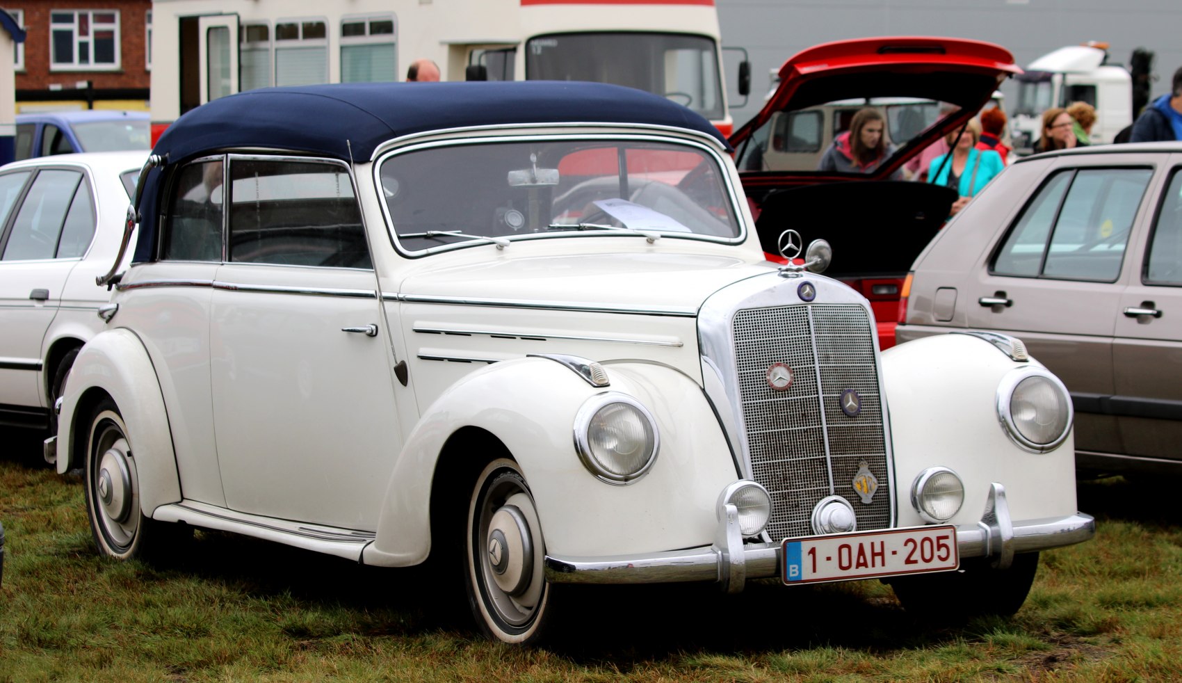 Retro convertible with soft roof and large front grille.